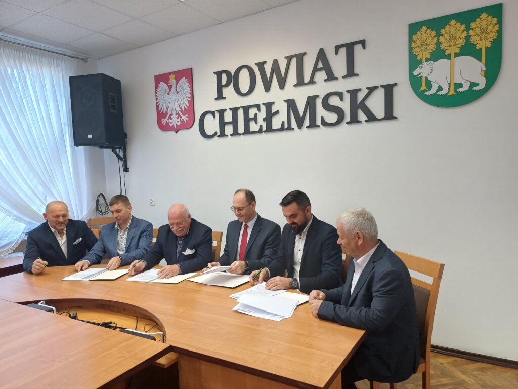 Sześć osób w tle napis: Powiat Chełmski